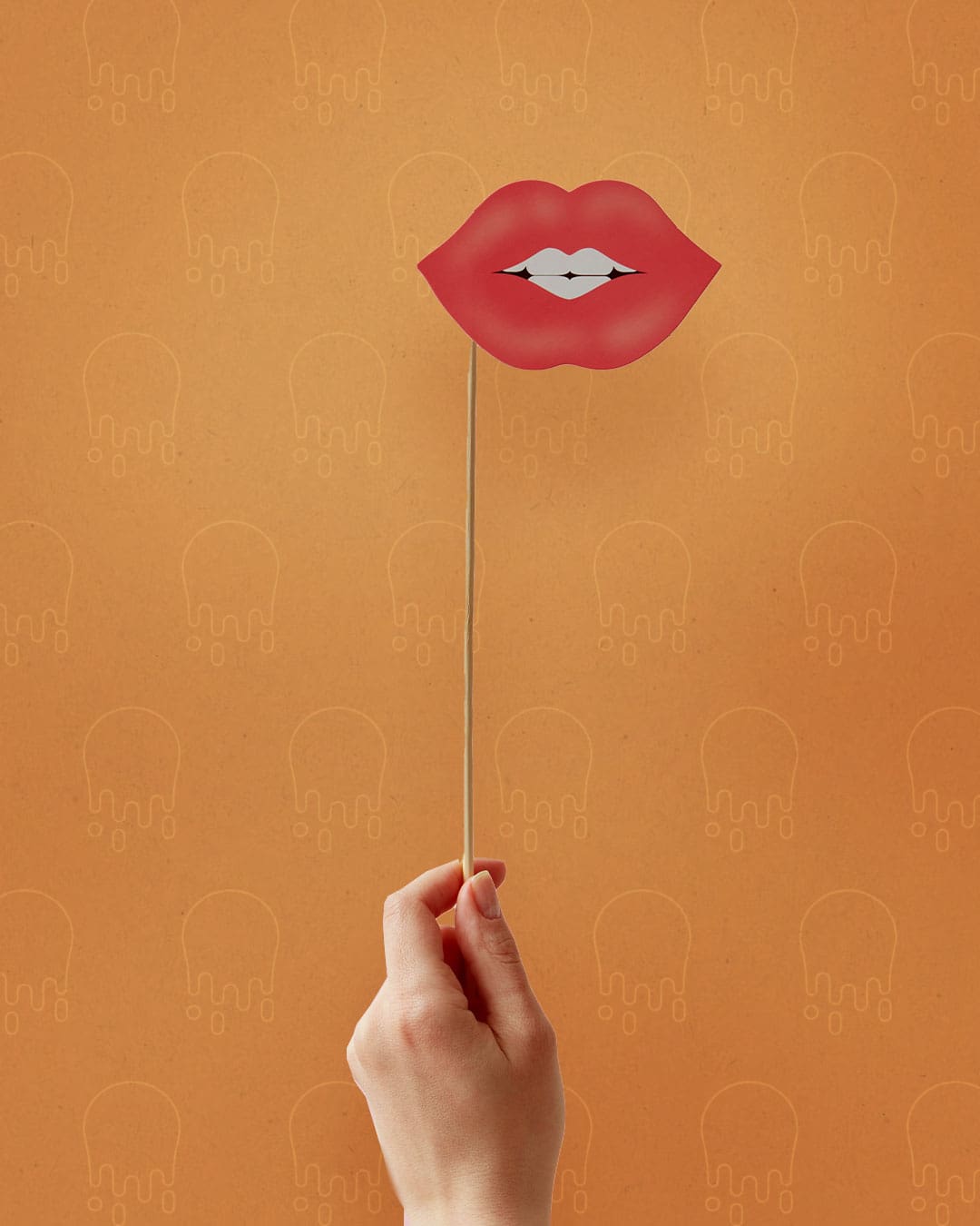 Hand holding sign with lips on orange background