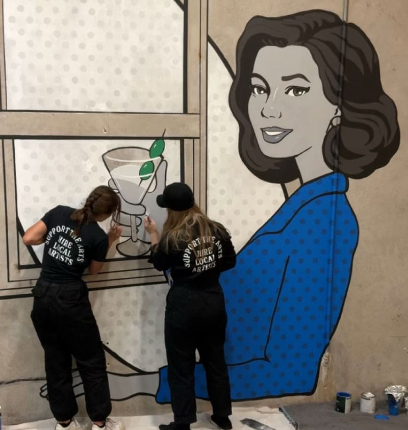 Lokal Color painting a pop up mural at Houston Window Experts